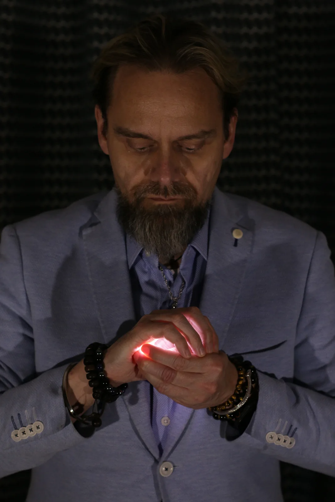 Shane Joseph performing magic with glowing light in his hands