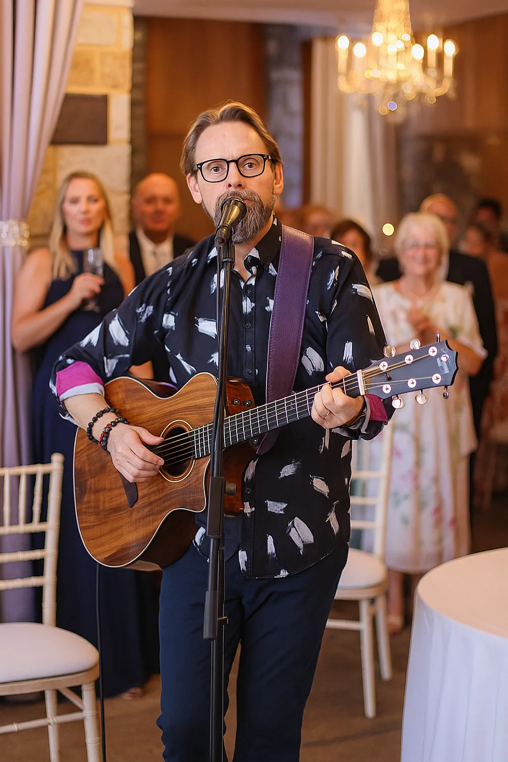 Shane Joseph singing and playing guitar at a wedding